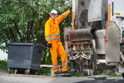 Customer loading waste into a hired skip